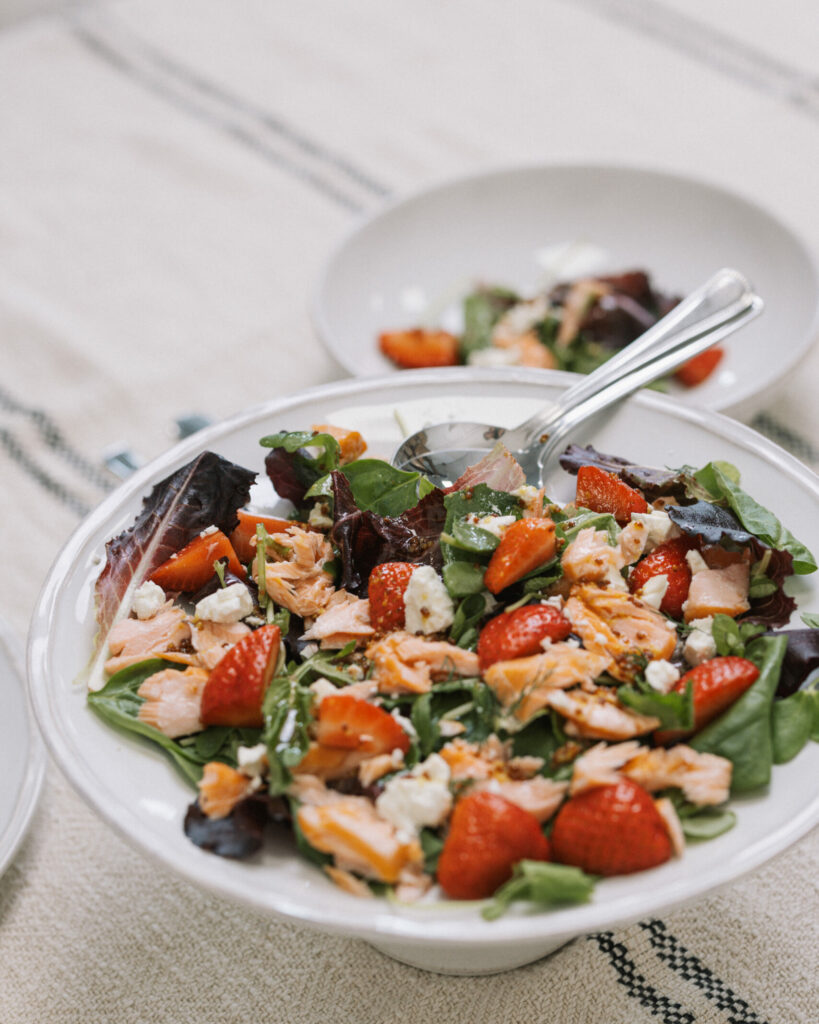 Salad with strawberries and greens on a large white plate - UGC food photography